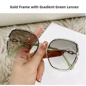 Detail of butterfly rimless sunglasses with gold metal frame and green gradient lenses