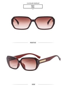 Detail view of square burgundy sunglasses with gold metal hollow decorative temples