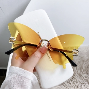 Lunettes de soleil papillon sans monture avec verres jaunes et détails en métal doré