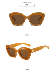 Front and 45-degree side view of tea colored cat eye sunglasses with gold metal accents