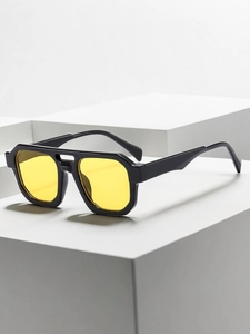 Detail of vintage double-bridge aviator sunglasses with black frame and yellow lenses
