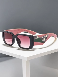 Detail of square oversized sunglasses with black frames and pink-green checkered temples