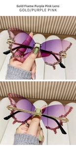 Macro shot of gold-framed rimless butterfly sunglasses with rhinestones and purple gradient lenses