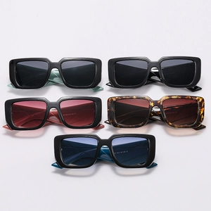 Five assorted colors of wide-frame rectangular sunglasses with flat lay arrangement
