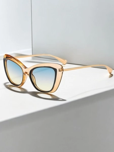 Close-up of cat-eye sunglasses with blue-yellow gradient lenses and amber frames