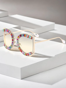 Detail der goldenen Sonnenbrille mit bunten Kristallen und perlenbesetzten Bügeln
