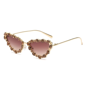 Luxurious cat-eye sunglasses with crystal-embellished frames and golden metal temples