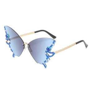 Frameless butterfly shaped sunglasses with gradient blue lenses and sparkling rhinestones