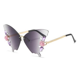 Frameless butterfly sunglasses with purple gradient lenses and rhinestone flower accents