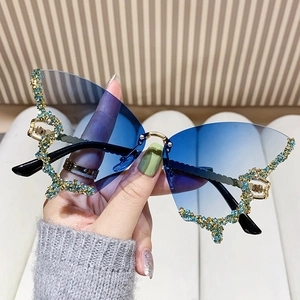 Handheld butterfly sunglasses with gradient blue lenses and rhinestone embellishments