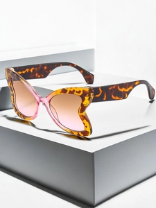 Detail of butterfly sunglasses with tortoiseshell frame and pink gradient lenses