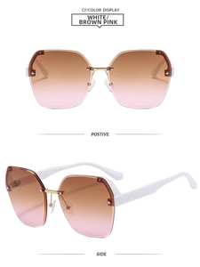 Detail of rimless gradient sunglasses featuring diamond texture white temples and gold bridge