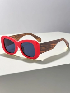 Detail view of bold red square sunglasses with thick tortoiseshell textured temples