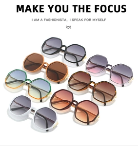 Detailed view of oversized hexagonal sunglasses in seven colors with metal hinge accents