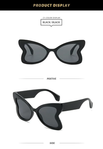 Detail view of bold butterfly shape black frame sunglasses showing front and side profile