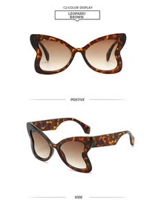 Detail view of butterfly frame leopard print sunglasses with brown gradient lenses