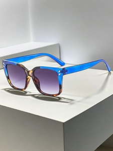 Detailed view of square blue and tortoiseshell frames with purple gradient lenses