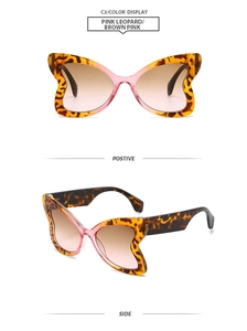 Detail view of butterfly frame sunglasses with pink leopard print and gradient brown lenses