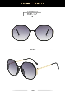 Detail of hexagonal black frames with gradient gray lenses and golden metal temples