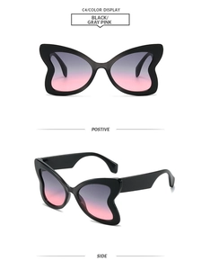 Detail view of butterfly frame sunglasses with wide temples and grey-pink gradient lenses