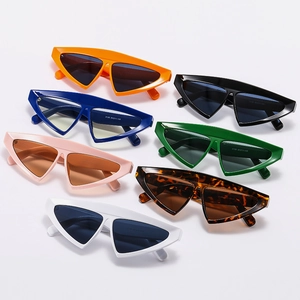 Flat lay of trendy triangle cat-eye sunglasses in seven vibrant colors with thick frames