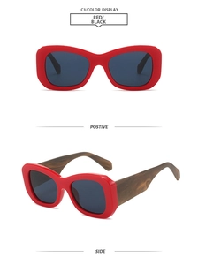 Detail of red wide frame sunglasses with thick wood texture temples and dark lenses