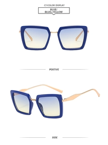 Detail of square blue sunglasses with yellow gradient lenses and gold metal temples