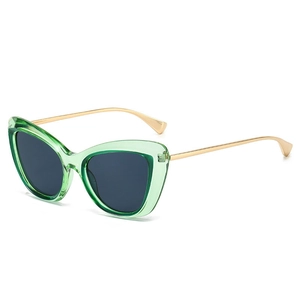 Retro cat-eye sunglasses with transparent green frames and slim gold metal temples