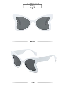 Detail view showing white butterfly frame sunglasses with dark lenses from multiple angles
