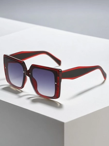 Detail of red and black textured square frame sunglasses with gradient lenses