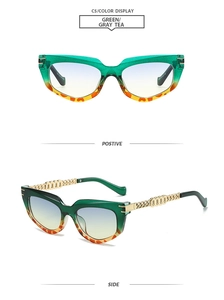 Cat eye sunglasses detail with green resin frames and golden metal chain temples