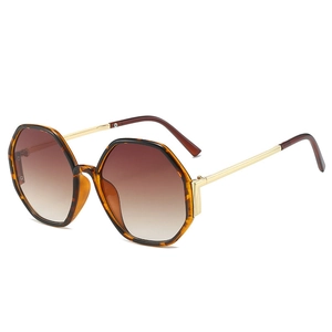 Octagonal tortoiseshell sunglasses with gold metal temples and brown gradient lenses