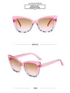 Detail view of pink and blue cat-eye sunglasses with gradient brown lenses and ornate frame