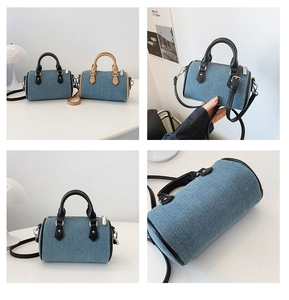 Detail showing the denim texture and contrast leather handles of this mini Boston bag