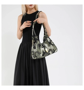 Detail view of the vintage camo handbag with gold buckle closure and dual top handles