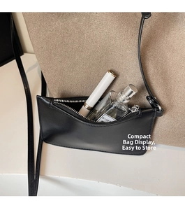 Detail of a black leather pouch with zipper showing storage for lipstick and perfume