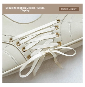 Detailed close-up of quilted cream leather bag featuring elegant satin ribbon bow lacing