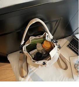 Macro view of large capacity canvas bucket bag interior holding daily essentials