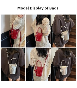 Detail view of mini bucket bag with glossy finish and cute bear charm in red and silver