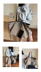Detail of canvas tote bag with black leather straps and detachable inner pouch