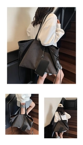 Detail of charcoal grey canvas tote bag with side drawstrings and matching small pouch