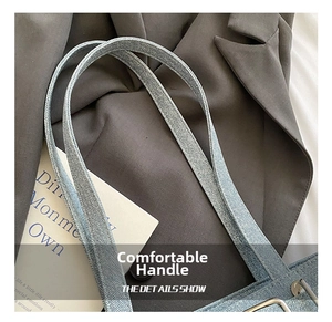 Detail of blue canvas shoulder bag strap with premium silver metal buckle hardware