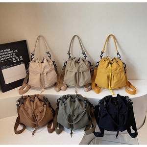 Collection of minimalist drawstring bucket bags in six colors with adjustable straps