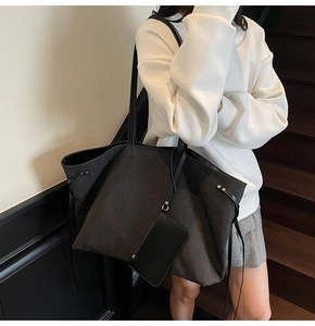 Detailed view of large grey tote bag with matching zippered pouch and side drawstring