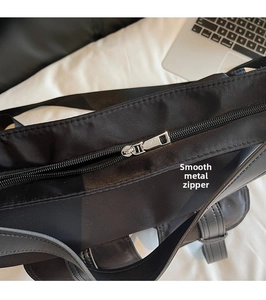 Close-up of the high-quality silver metal zipper on a black nylon commuter tote bag