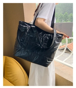 Détail du grand sac cabas noir brillant montrant le tissu en nylon imperméable
