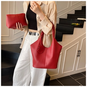 Red lychee pattern leather tote bag and matching zipper clutch bag set on model