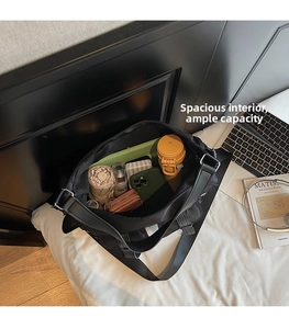 Internal view of black tote bag showing large capacity for umbrella, phone and cosmetics