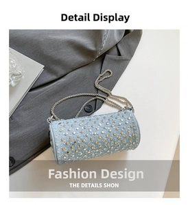 Close-up of light blue cylindrical studded crossbody bag with silver chain strap