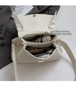 Detailed view of the spacious inner compartments of the cream pebble leather bag